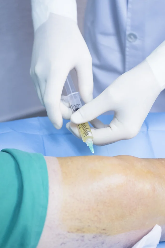 close-up-doctor-injecting-syringe-patient-leg-operating-room